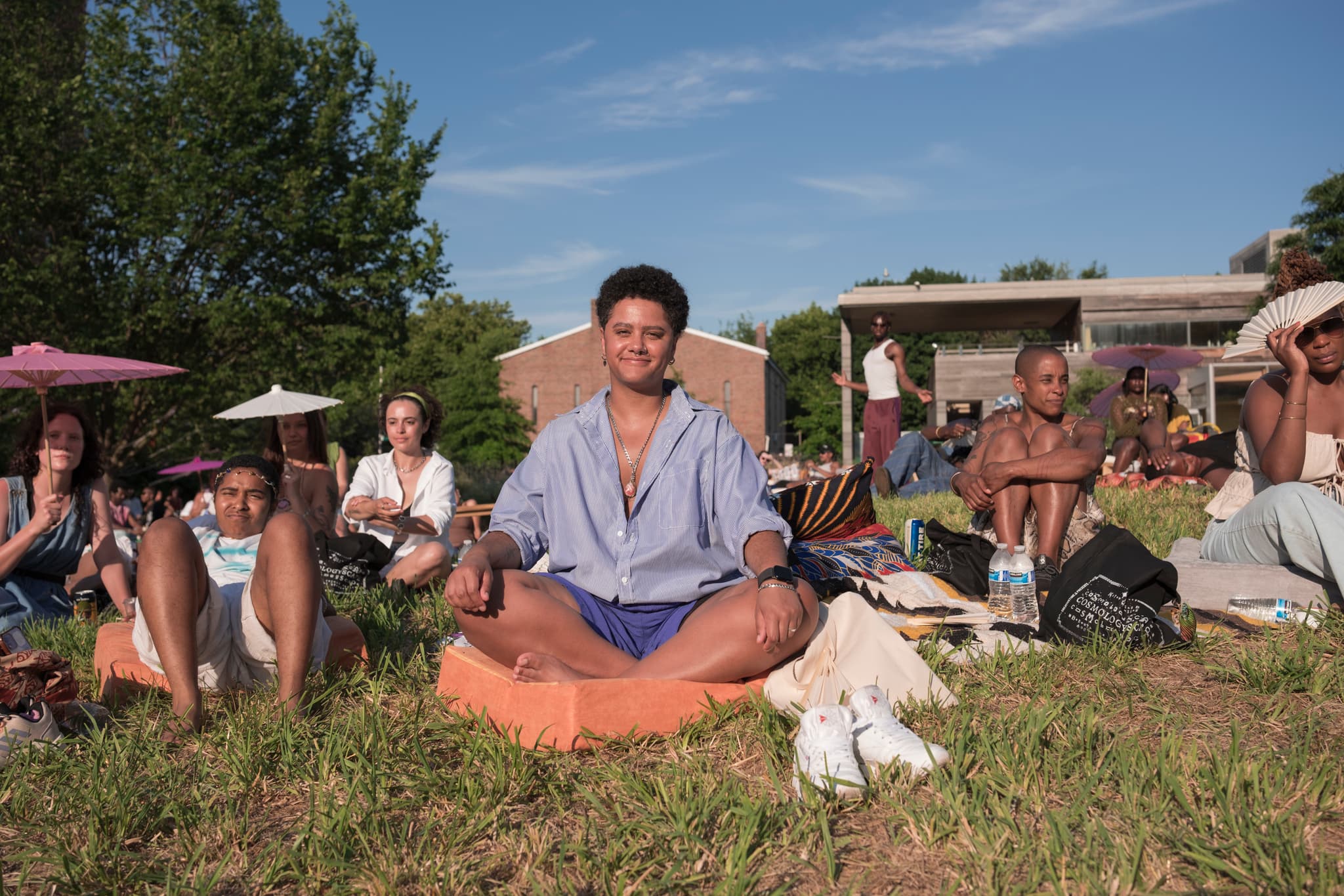 A person meditates outdoors on a sunny day.