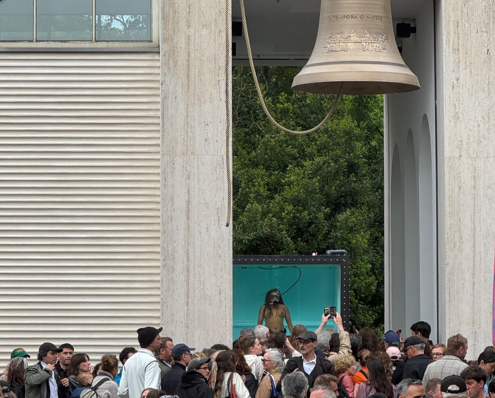 A performance feature a water tank and bell takes place at the Venice Biennale.