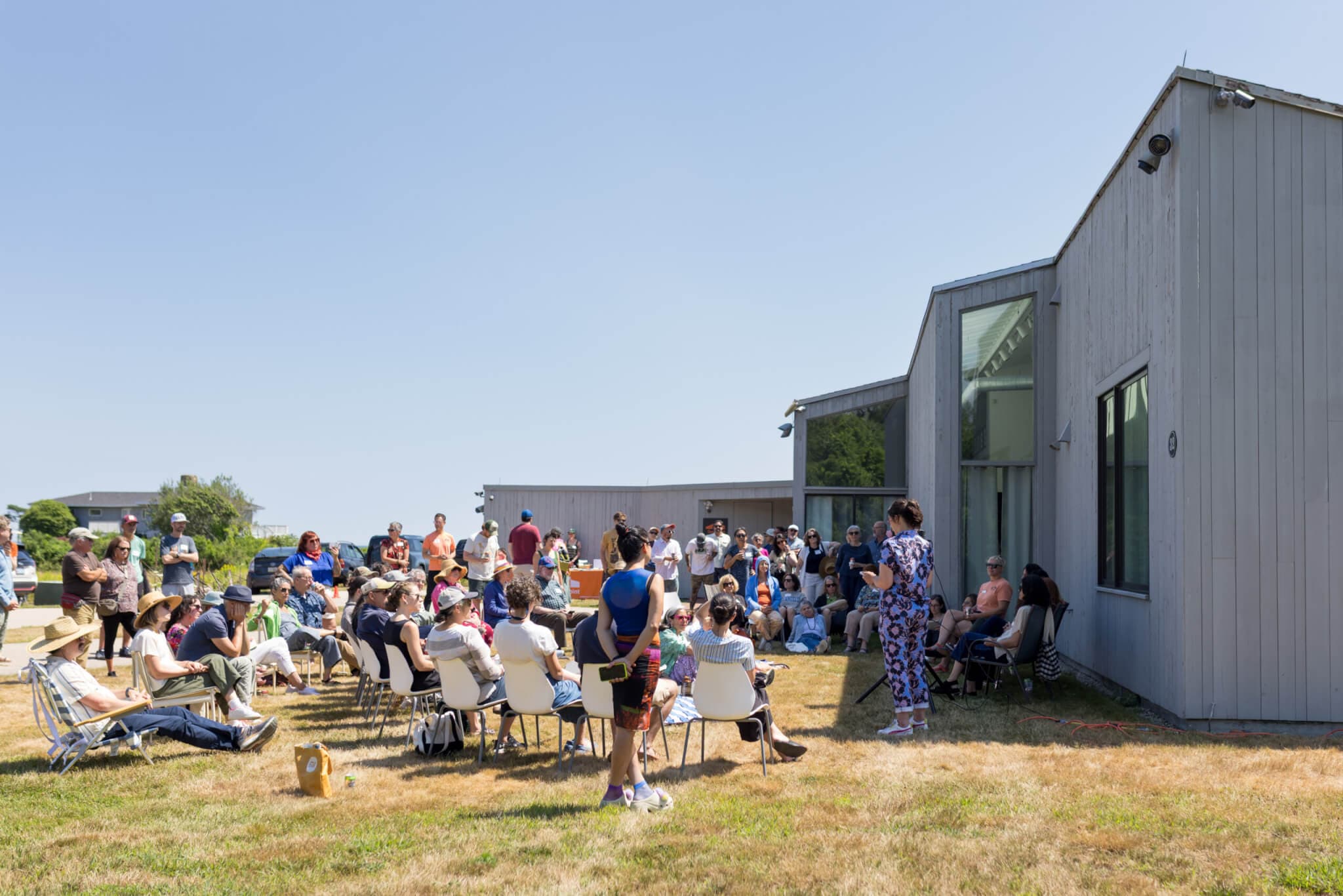Introductions are made before an outdoor audience before a panel discussion.